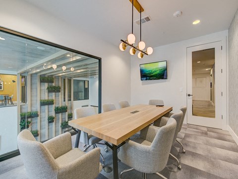 a dining room with a wooden table and chairs